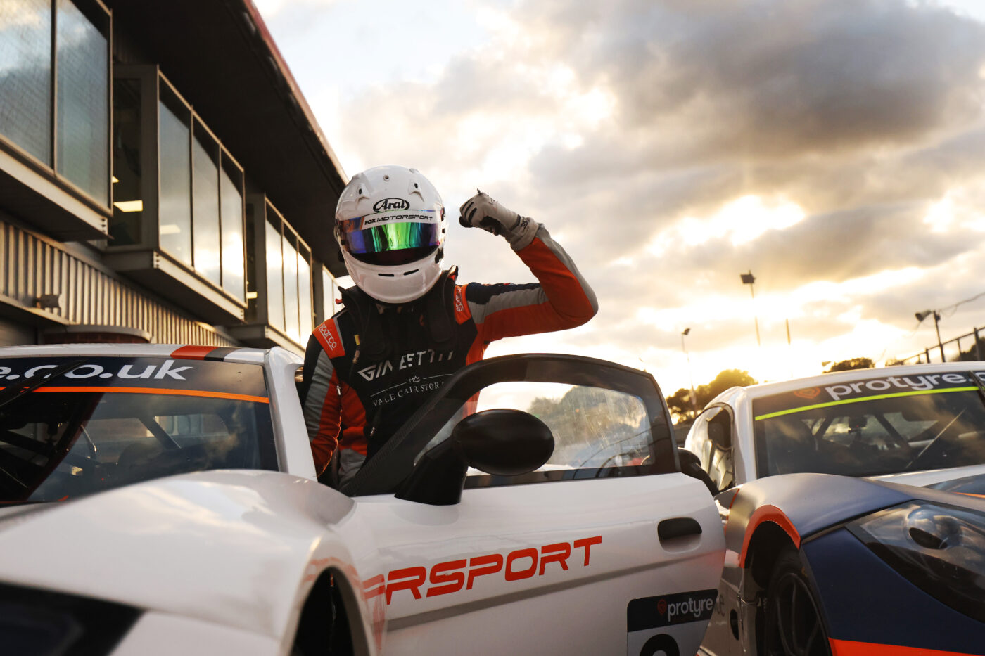 racer celebrating as he gets out of a race car